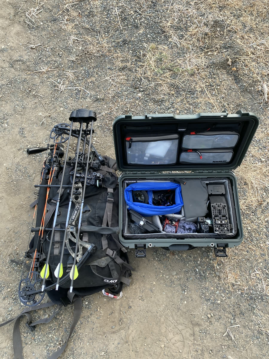 Cinema camera kit and archery equipment packed for a field shoot
